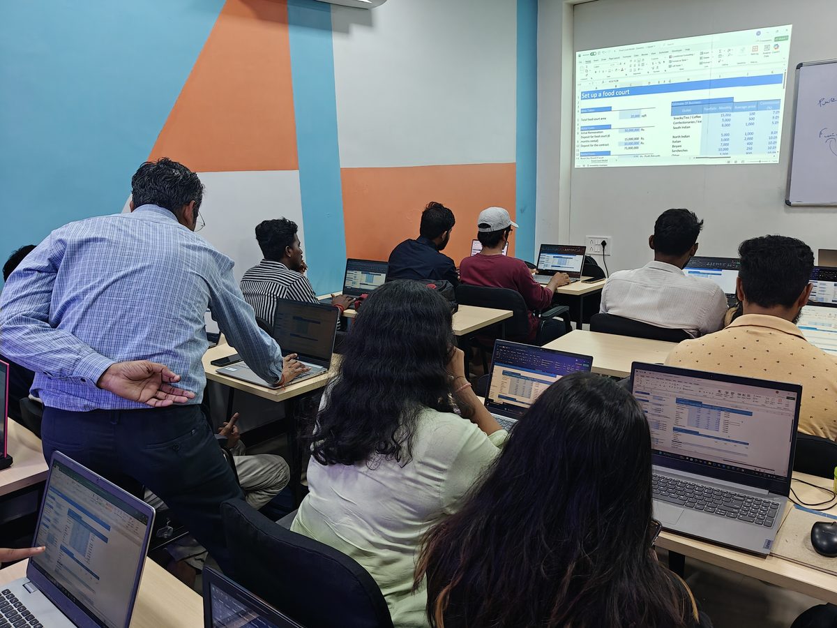 Students working through a spreadsheet exercise with faculty at SkilledGrad